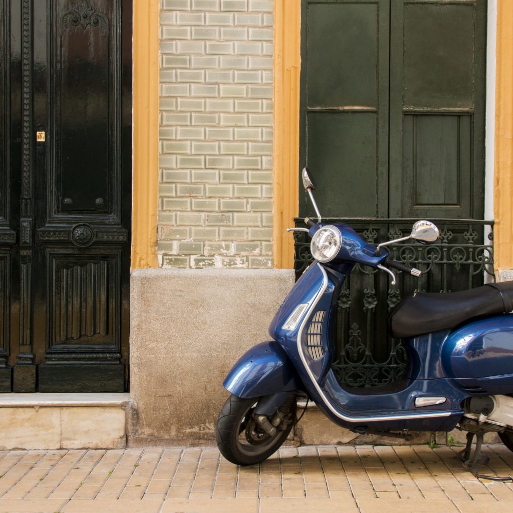 View of a vintage vespa scooter parked on a spanish town.